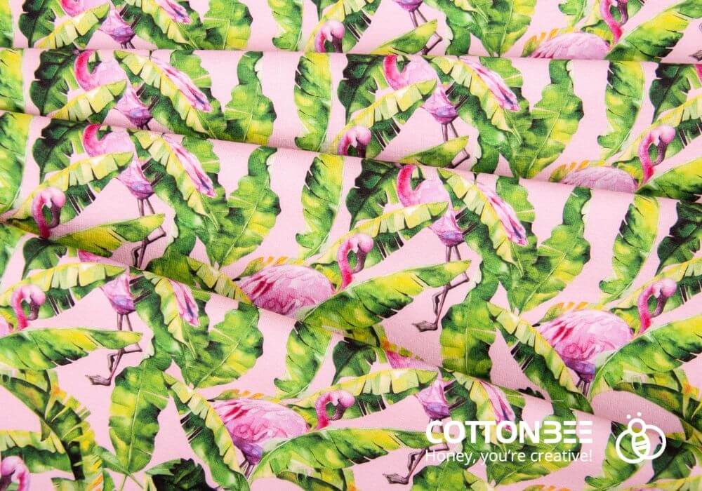 fabric with tropical leaves and pink flamingos