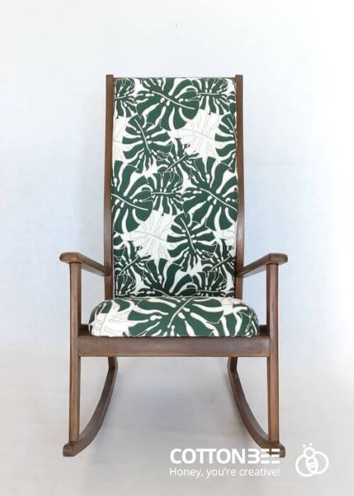 A chair with gabardine cover with monstera leaf - fabric printing