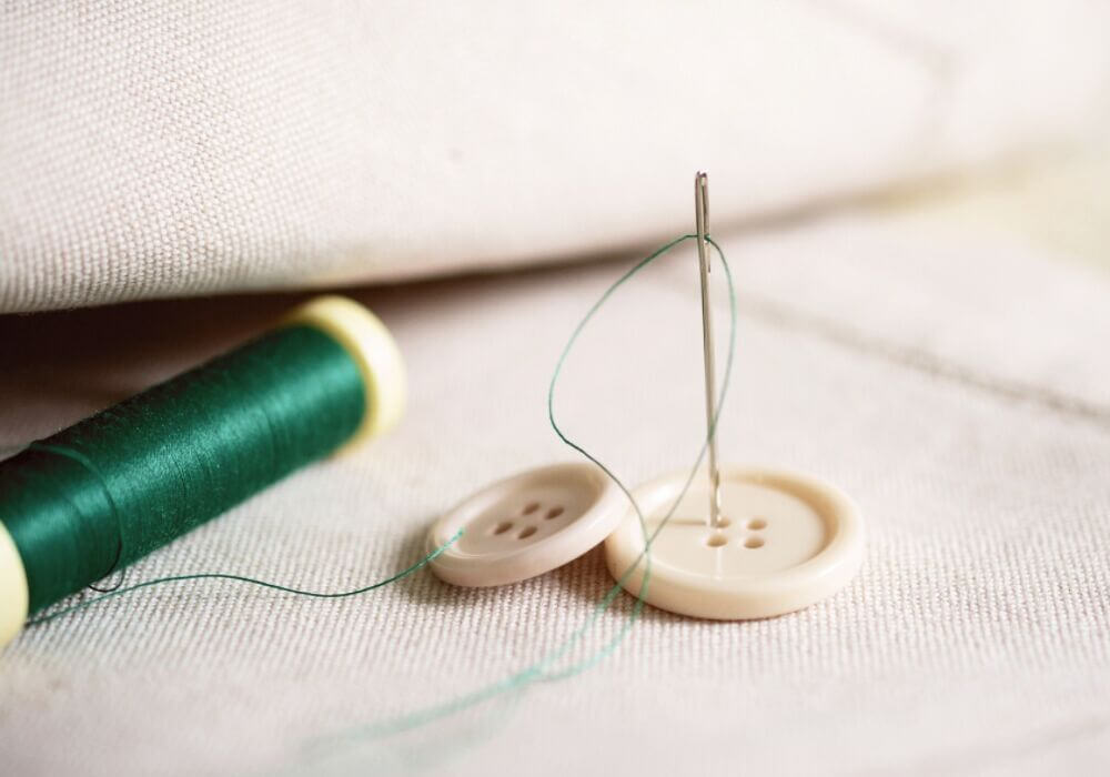 Sewing on a button by hand